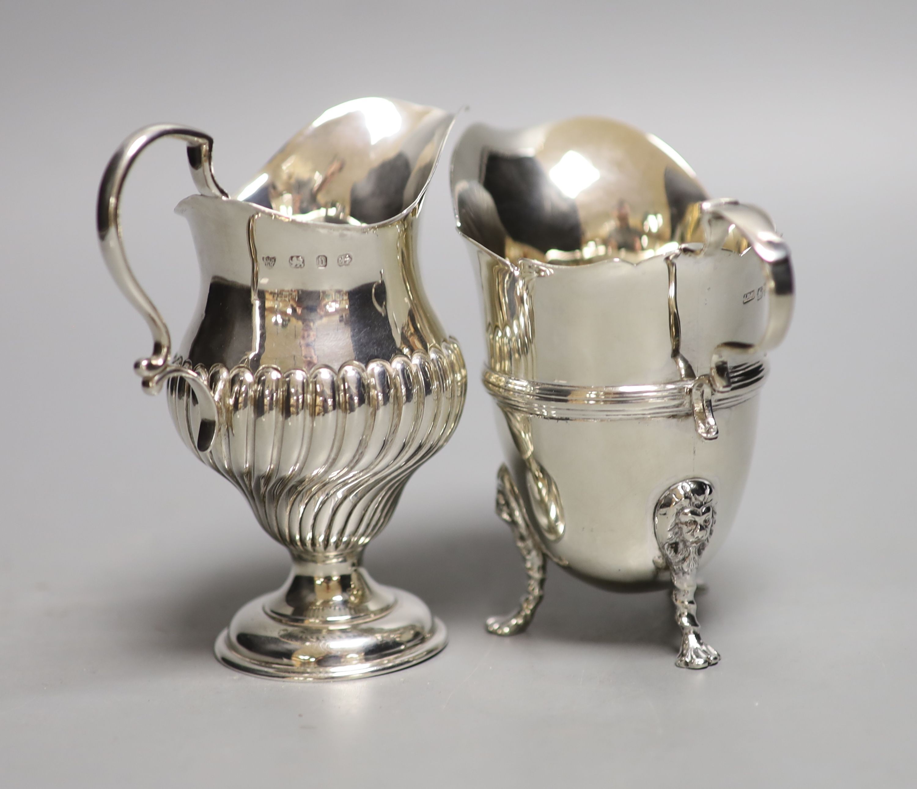 A late Victorian silver inverted pear shaped cream jug, Birmingham, 1894, 10.6cm, and a later silver cream jug, 8oz.